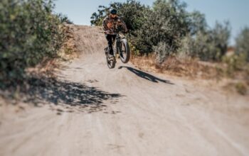 Fat tire electric bike equipped with autonomous driving technology on a forest trail.